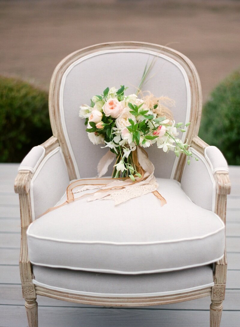 chair with peach ant white bride bouquet