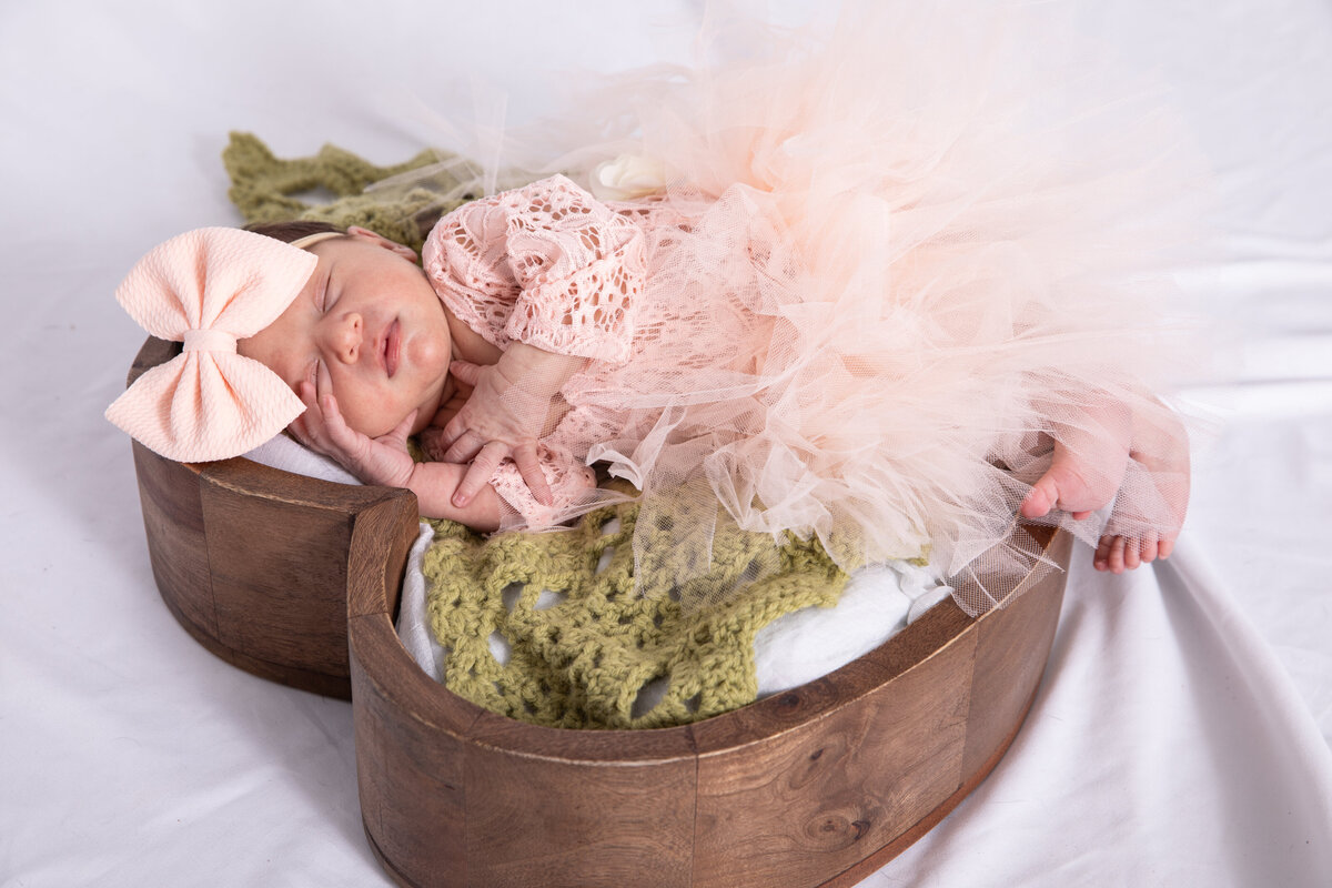 newborn in tutu in wooden heart