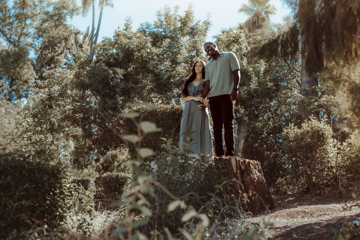 Couple Standing on Tree Stump – Redlands Outdoor Couples Session