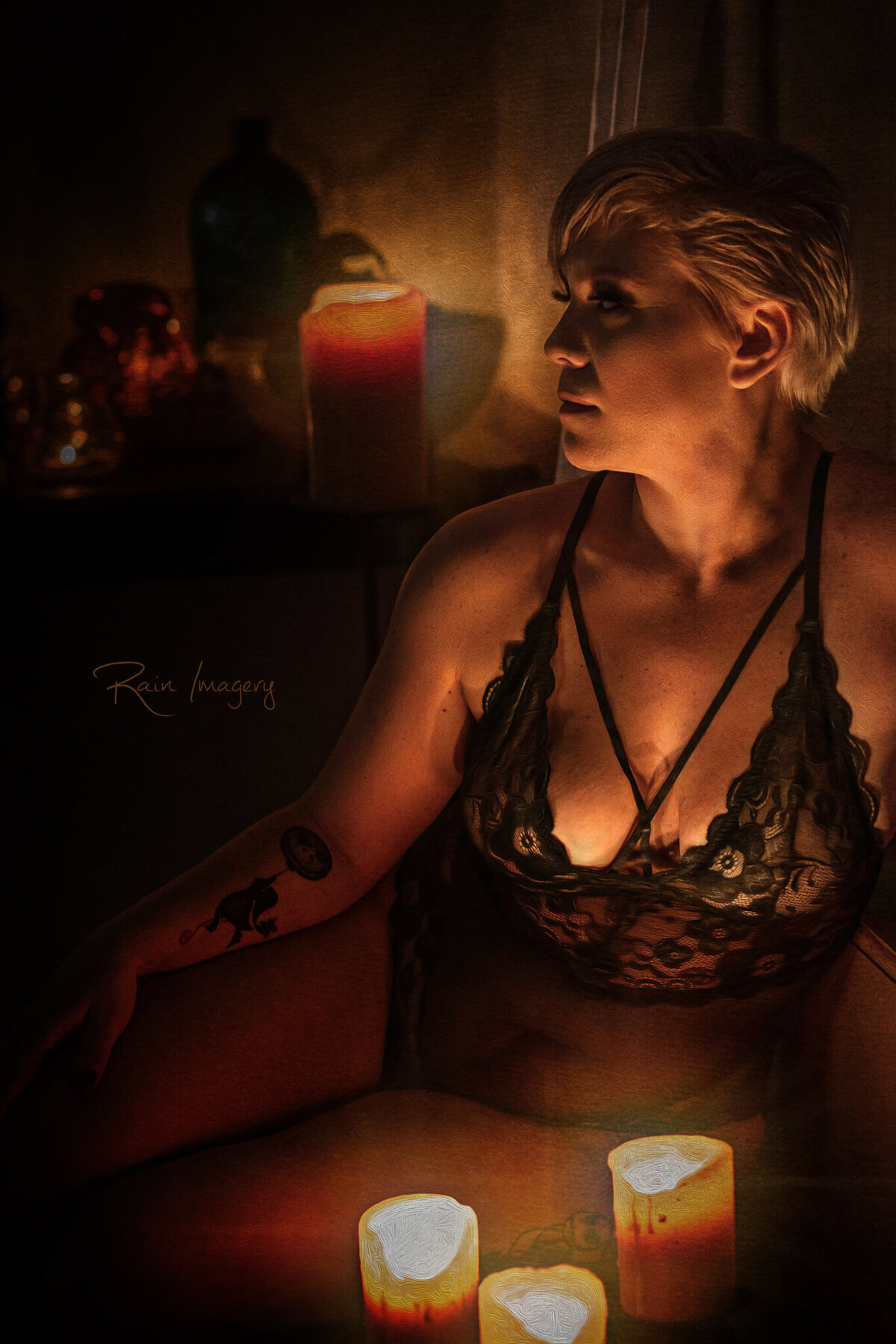 Boudoir photo of a woman with short blond hair with candles
