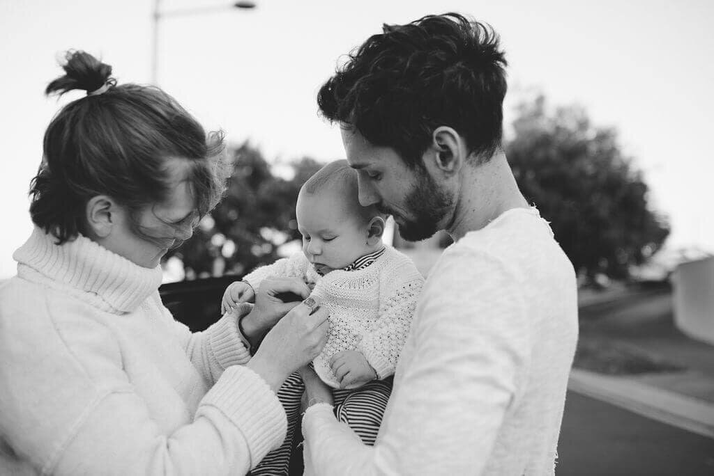 sydney-beach-parents-changing-baby-on-windy-day-candid