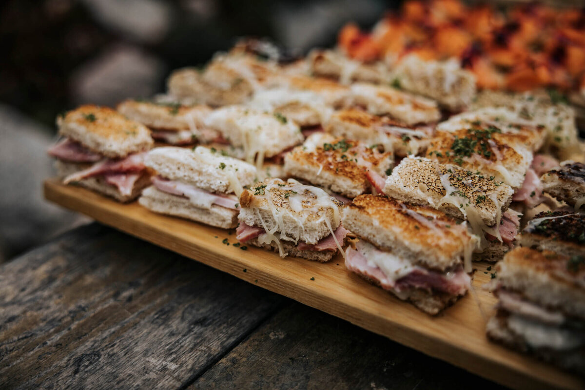A wooden cutting board topped with lots of food