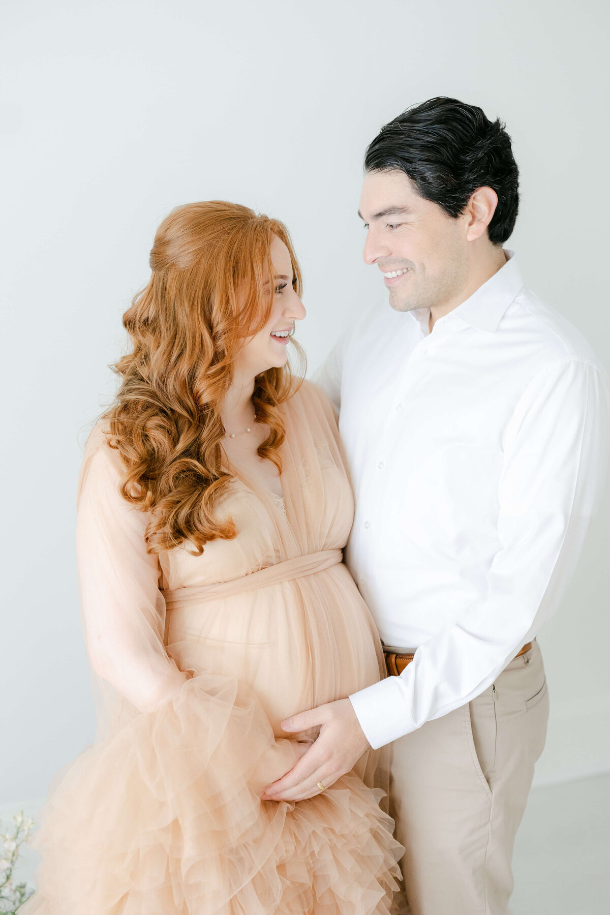 a pregnant woman smiling at her husband