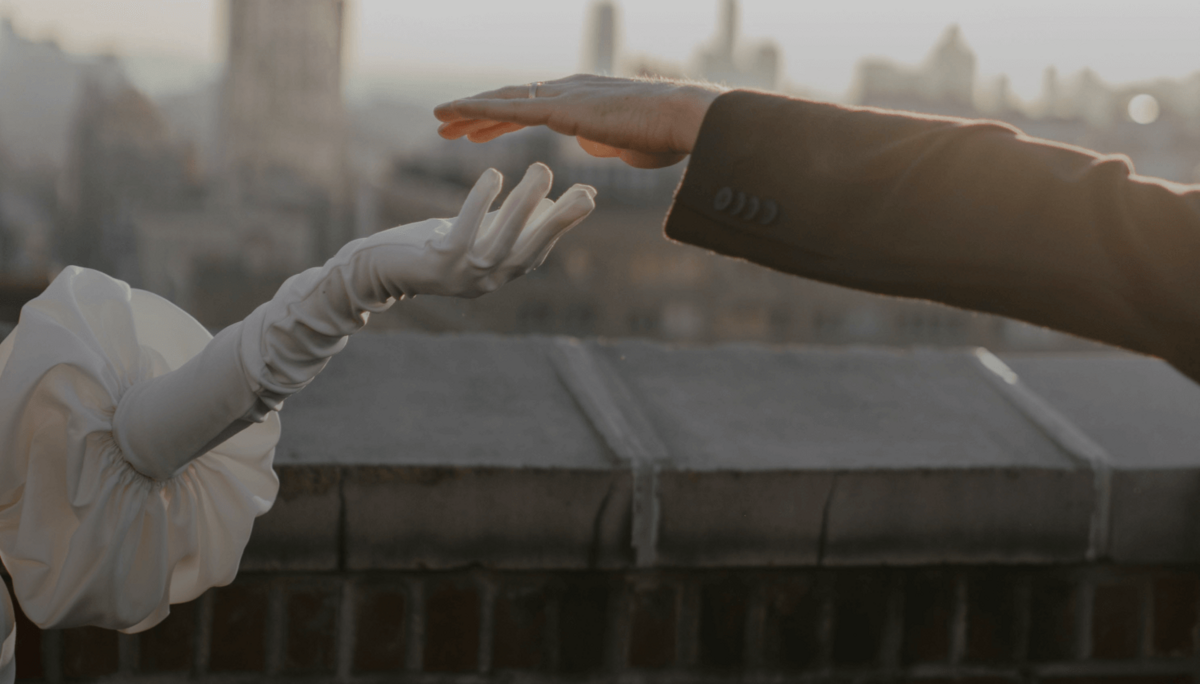 Two hands coming together after celebrating an engagement