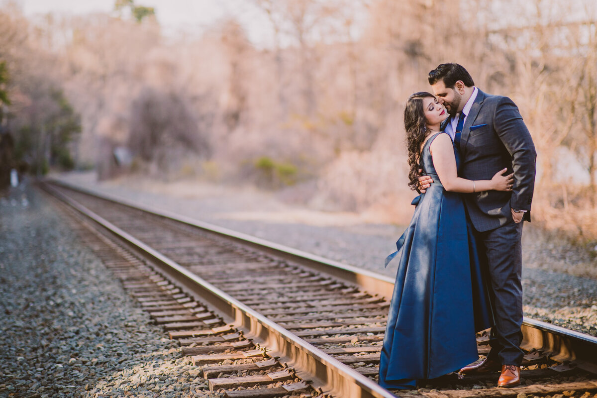 A couple standing on cargo railroad tracks at bear mountain state park in ny