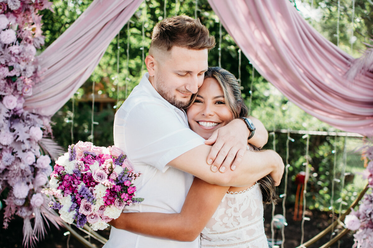 Bride and Groom hugging each other after their backyard wedding ceremony in Streamwood, IL
