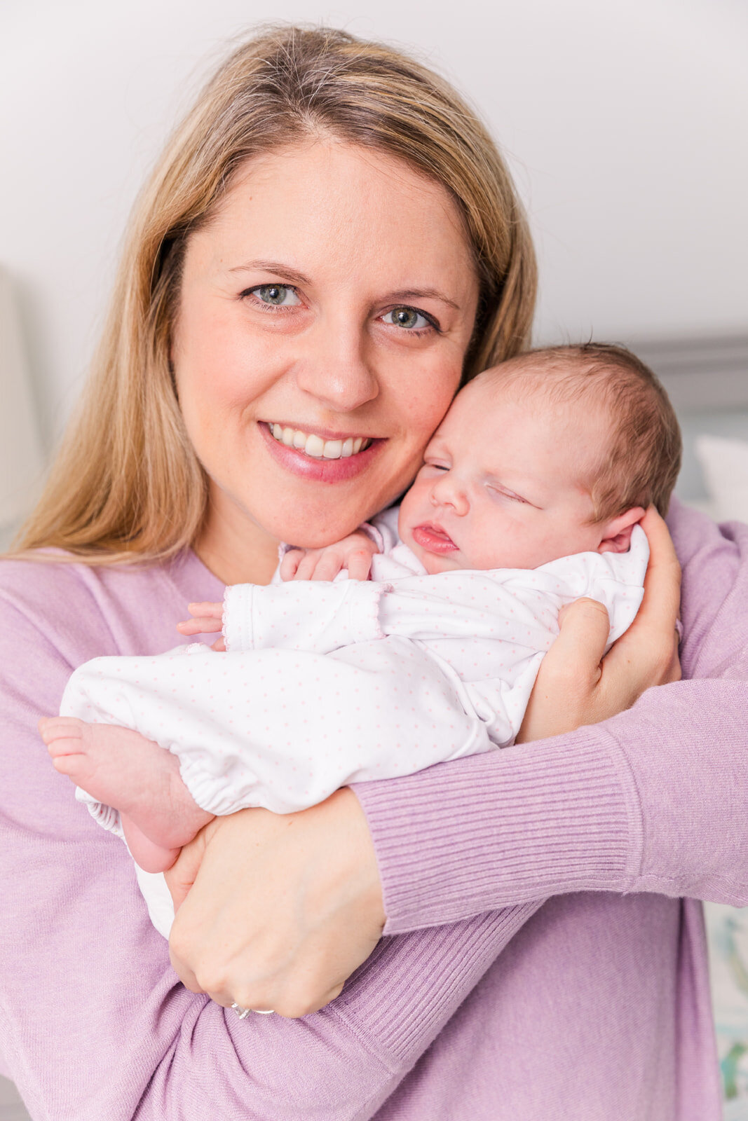 mum holing newborn baby face to face