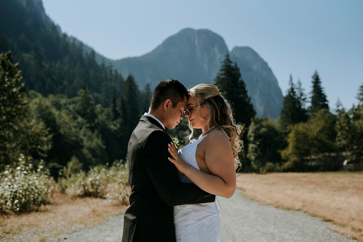 Squamish wedding couple share a moment alone under the watch eye of the Squamish Chief