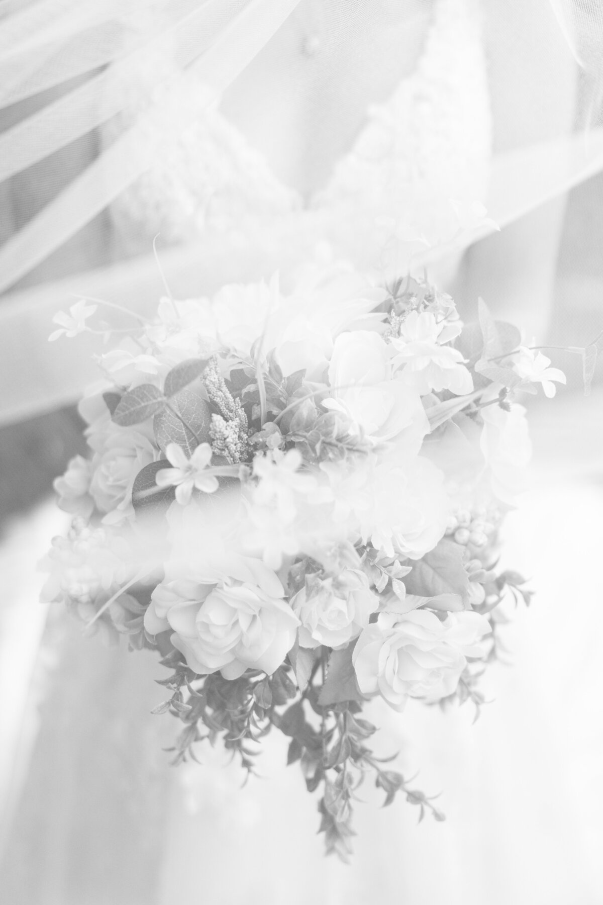 Black and white image of bride holding her wedding bouquet during Boston bridal portraits