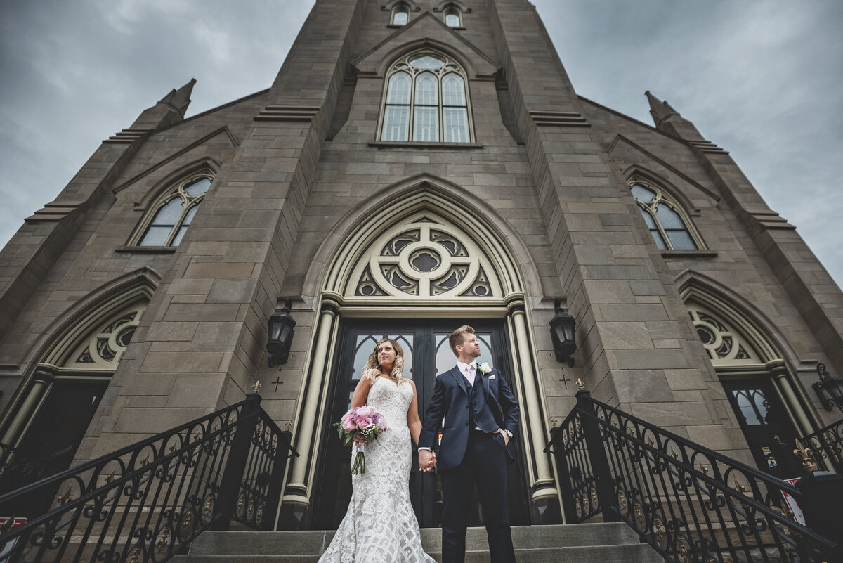 Dramatic wedding pose in front of Saint Joseph church in Erie PA.