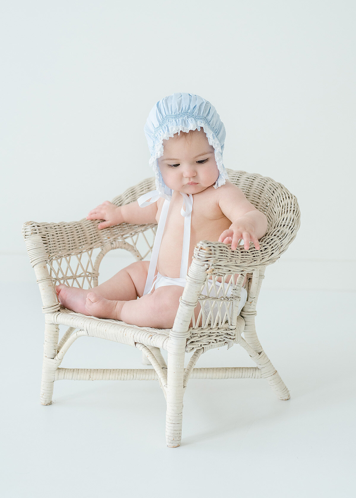 baby girl photographed in a feltman brothers bonnet and diaper cover in a st simons island photo studio