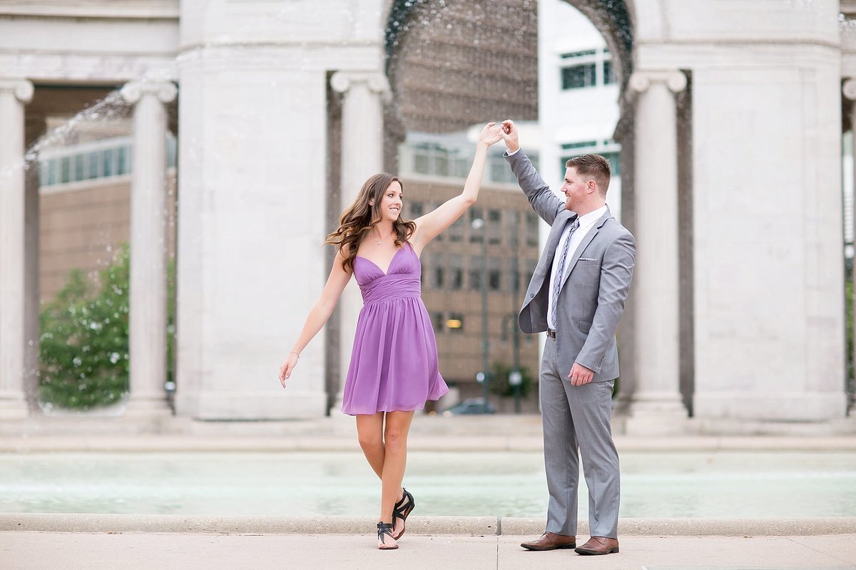 couple dancing in a park in Denver for their engagement photos
