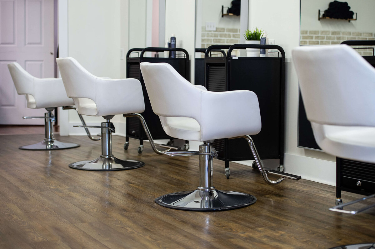 four white hair station chairs in a row at Richardson Hair Design.  Captured by Ottawa branding photographer JEMMAN Photography