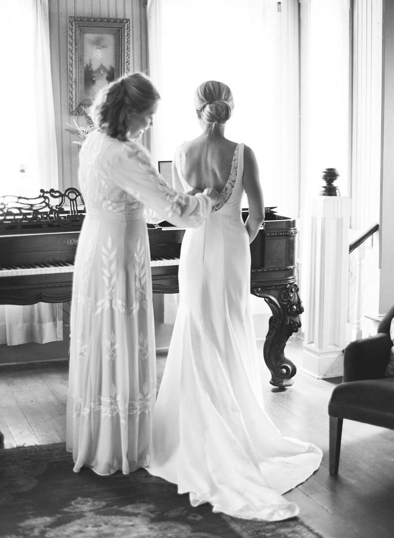 Black and White of Bride Getting in Dress in Highlands North Carolina Photo