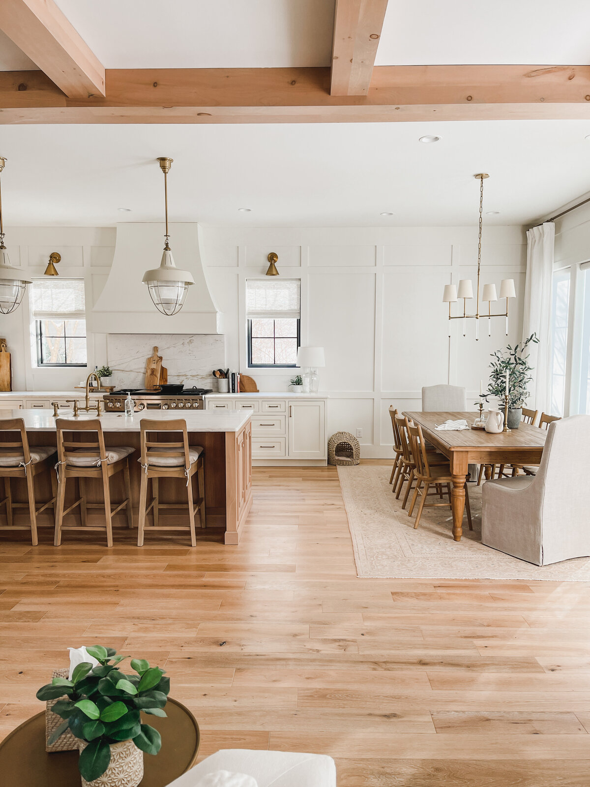 The open kitchen and dining room are perfect for entertaining and are gently lit by custom pendants and a chandelier