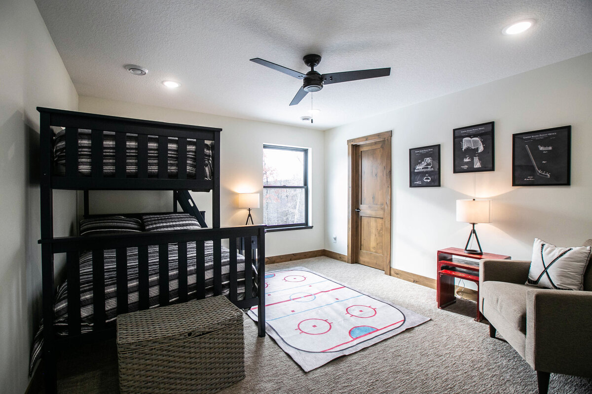 Secondary bedroom in custom Elk River home with natural light and neutral tones