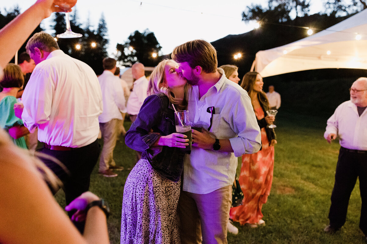 Wedding guests kissing at Dallenbach Ranch Wedding Colorado
