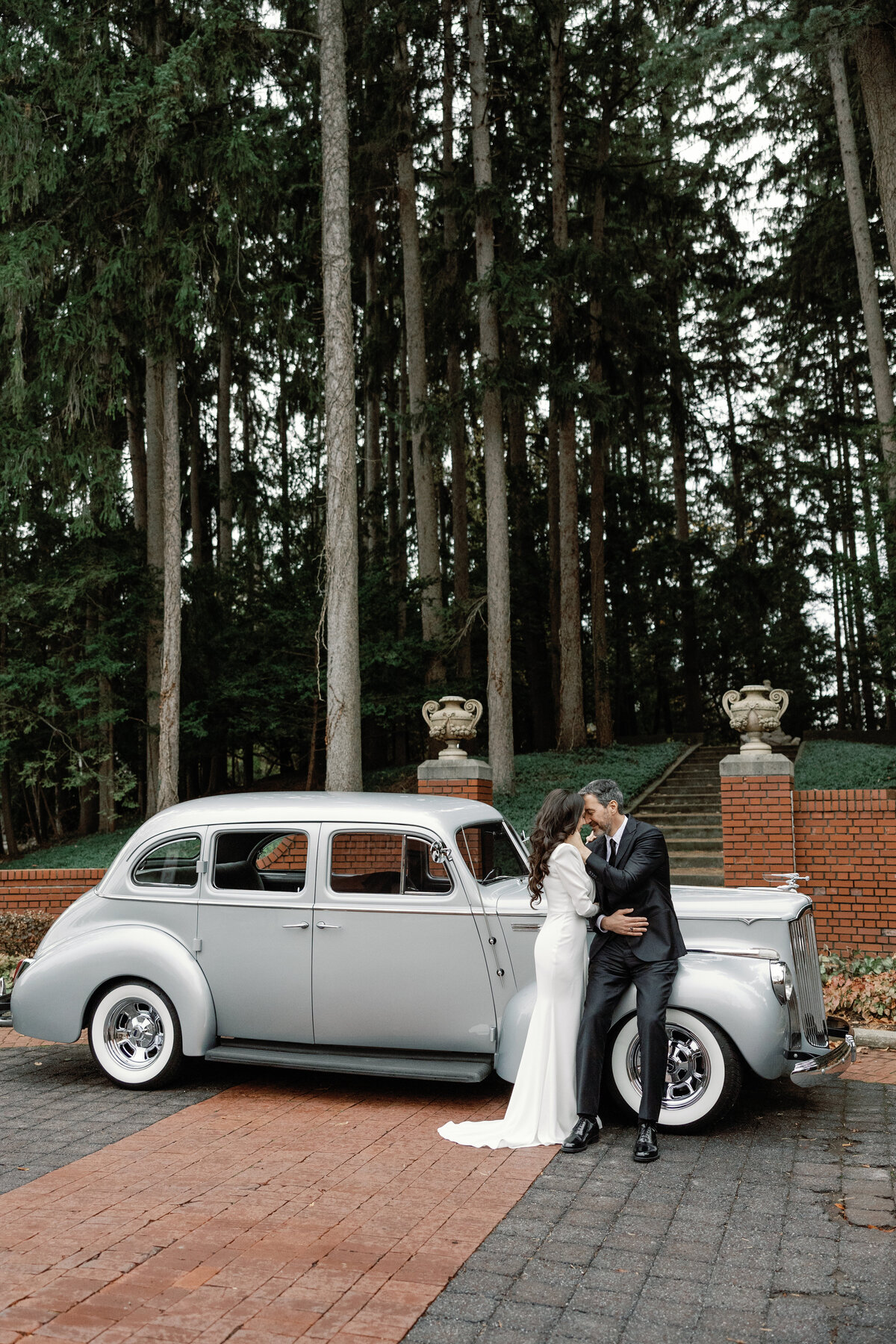 Photos of a bride and groom with a vintage car at cranbrook house and gardens in michigan