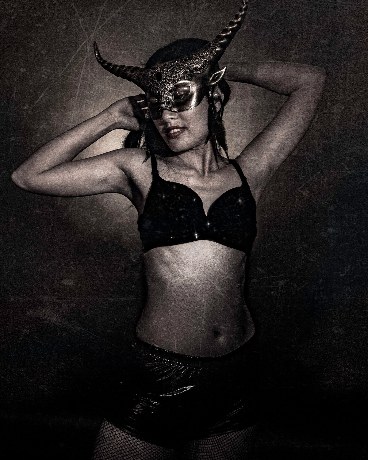 Black and white woman wearing mask and lingerie