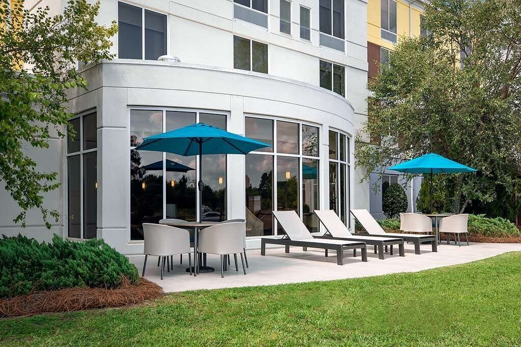 Lush greenery and hotel exterior with patio