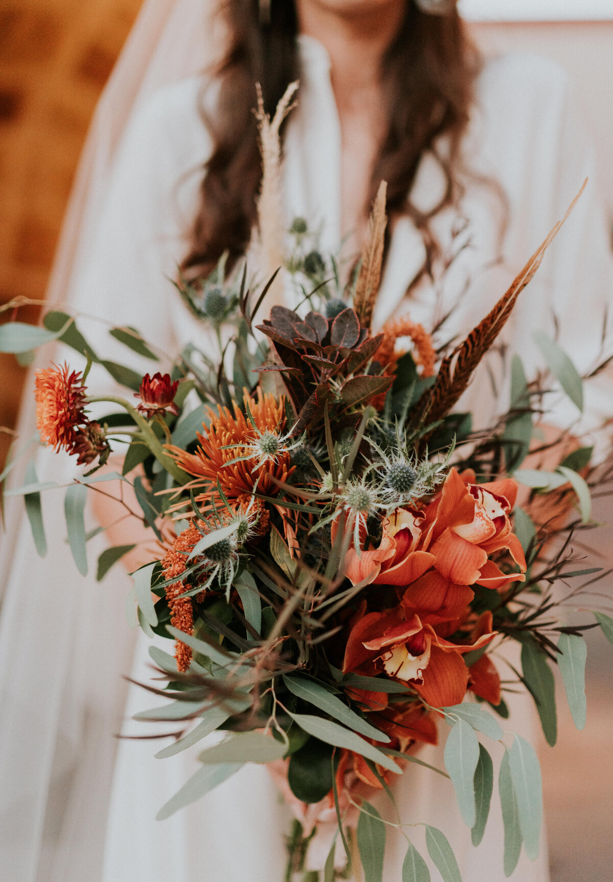 Orange, sage, and brown wedding bouquet.