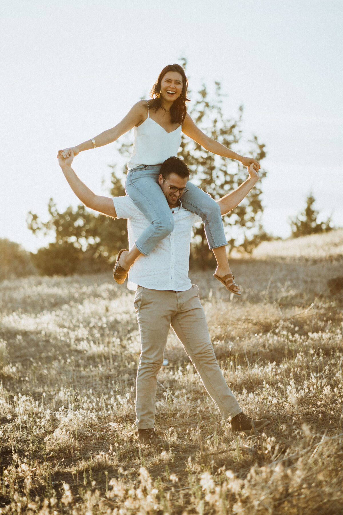 Girl on guy's shoulders during Bend, OR engagement photos