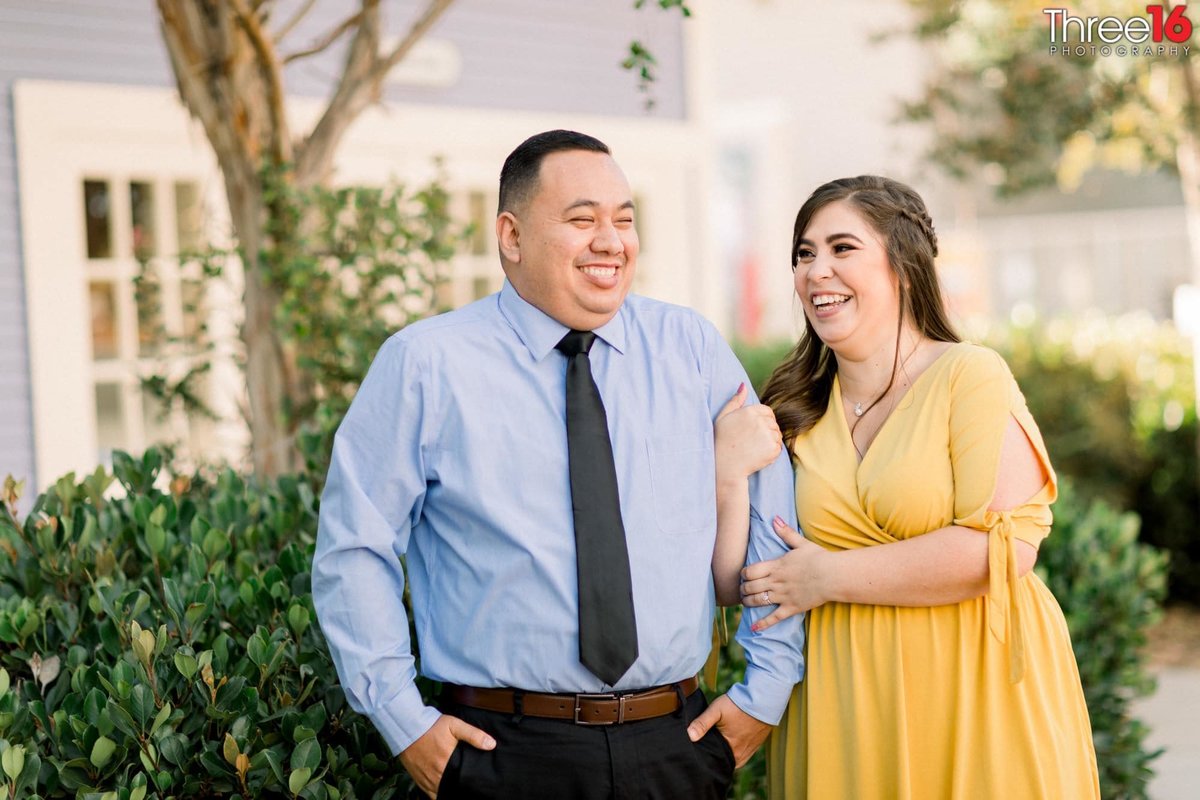 Engaged couple shares a laugh during photo session