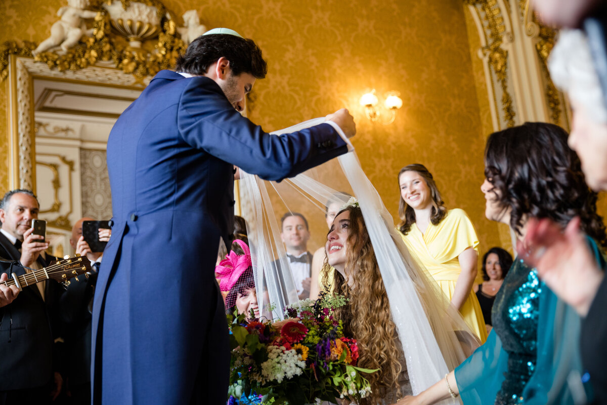 Groom lifts Veil of the Bride