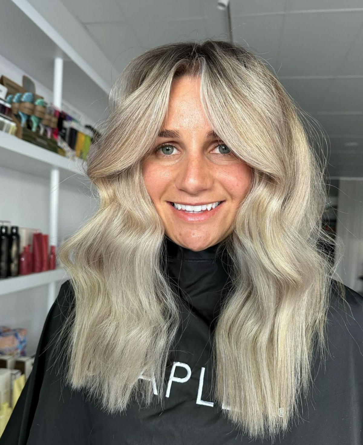 Girl smiling with green eyes and blonde curled hair