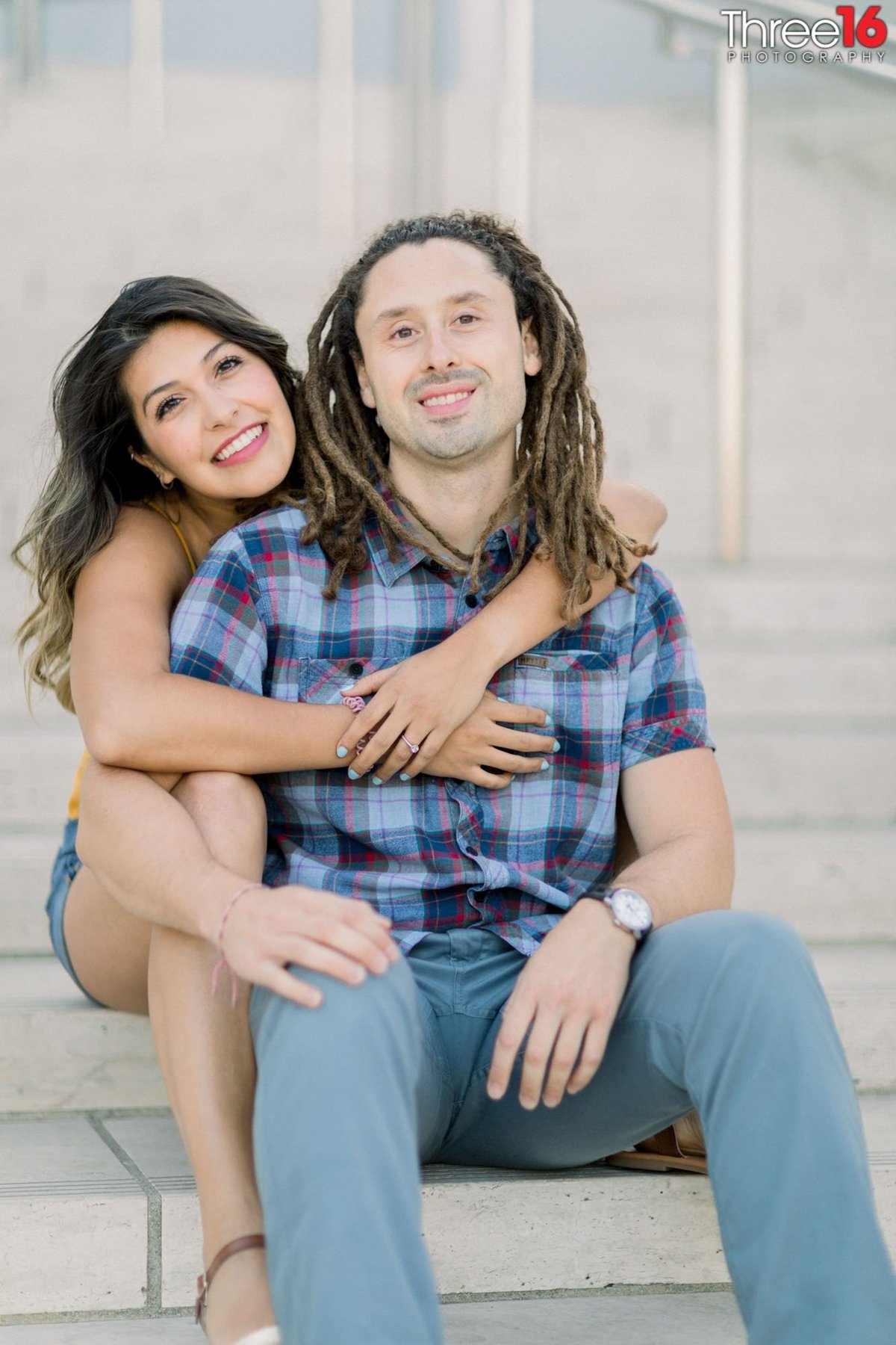 Engaged  couple get cozy as they pose for engagement photos in LA