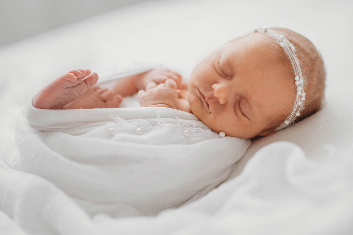Best Baby Photographer in Charleston, SC poses Infant for Newborn Photoshoot.