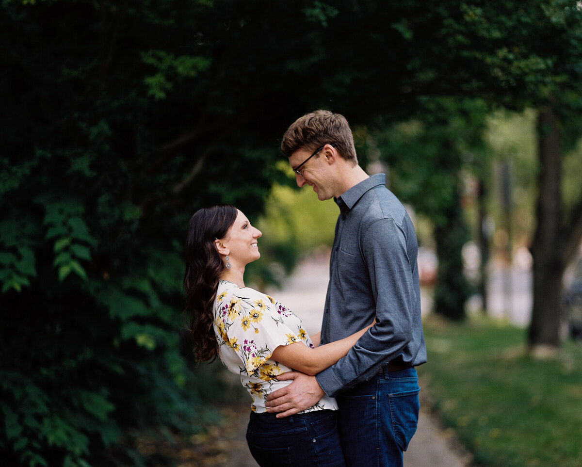 Couple poses under greenery in German Village