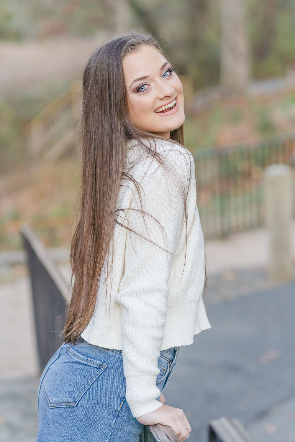 girl leaning by the railing during senior pictures in Prince William County, Virginia