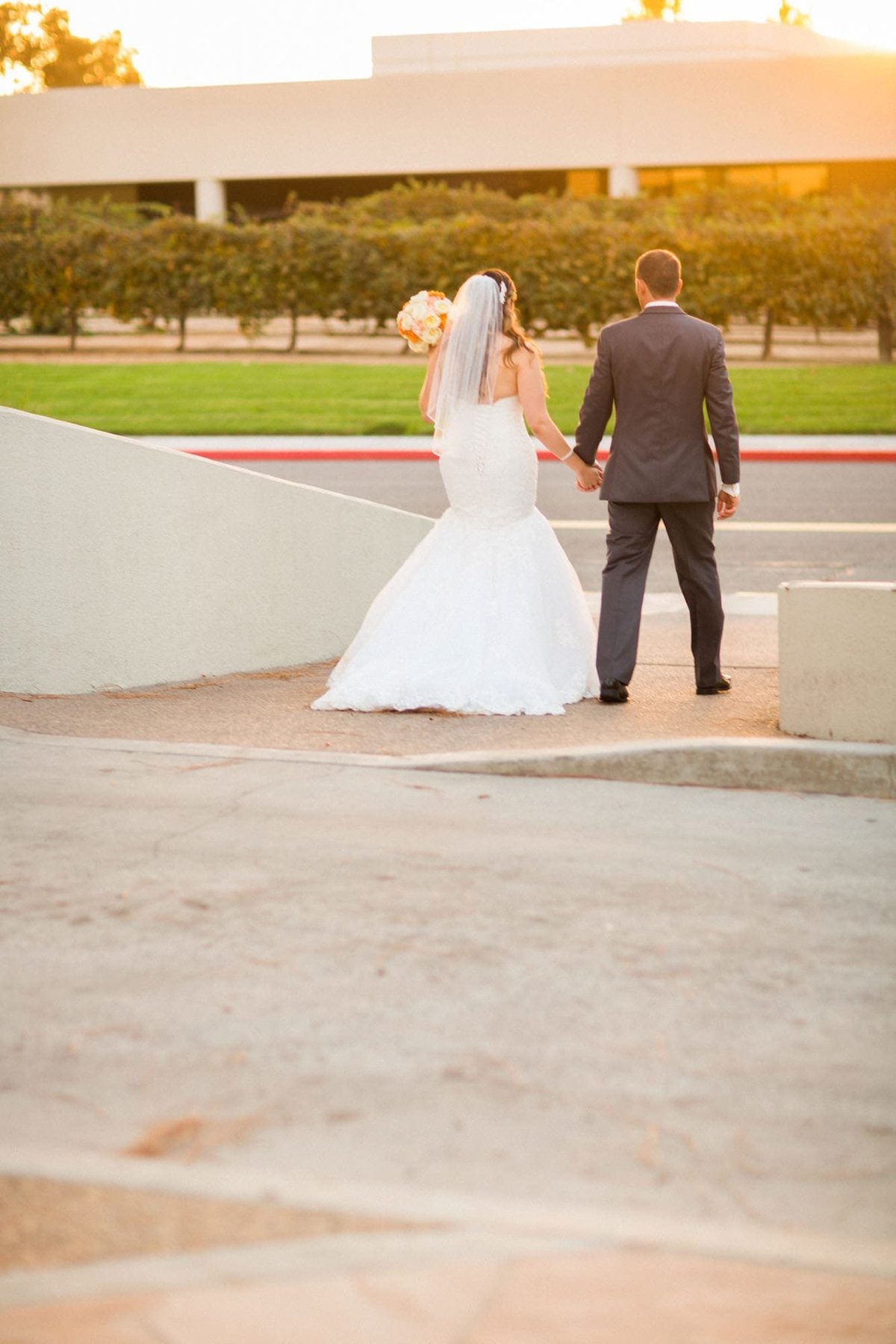 Bride and Groom walk away holding hands