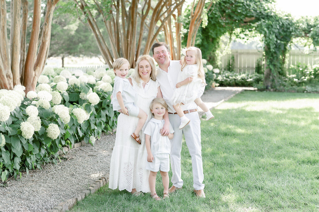 Family of 5 stands in front white hydrangeas in Franklin, TN