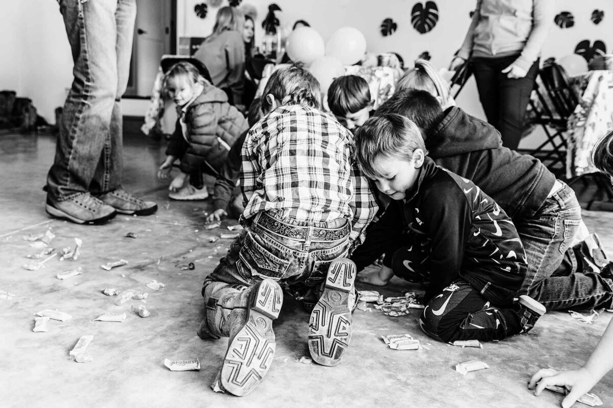 Kids grabbing pinata candy off floor at Montana birthday party