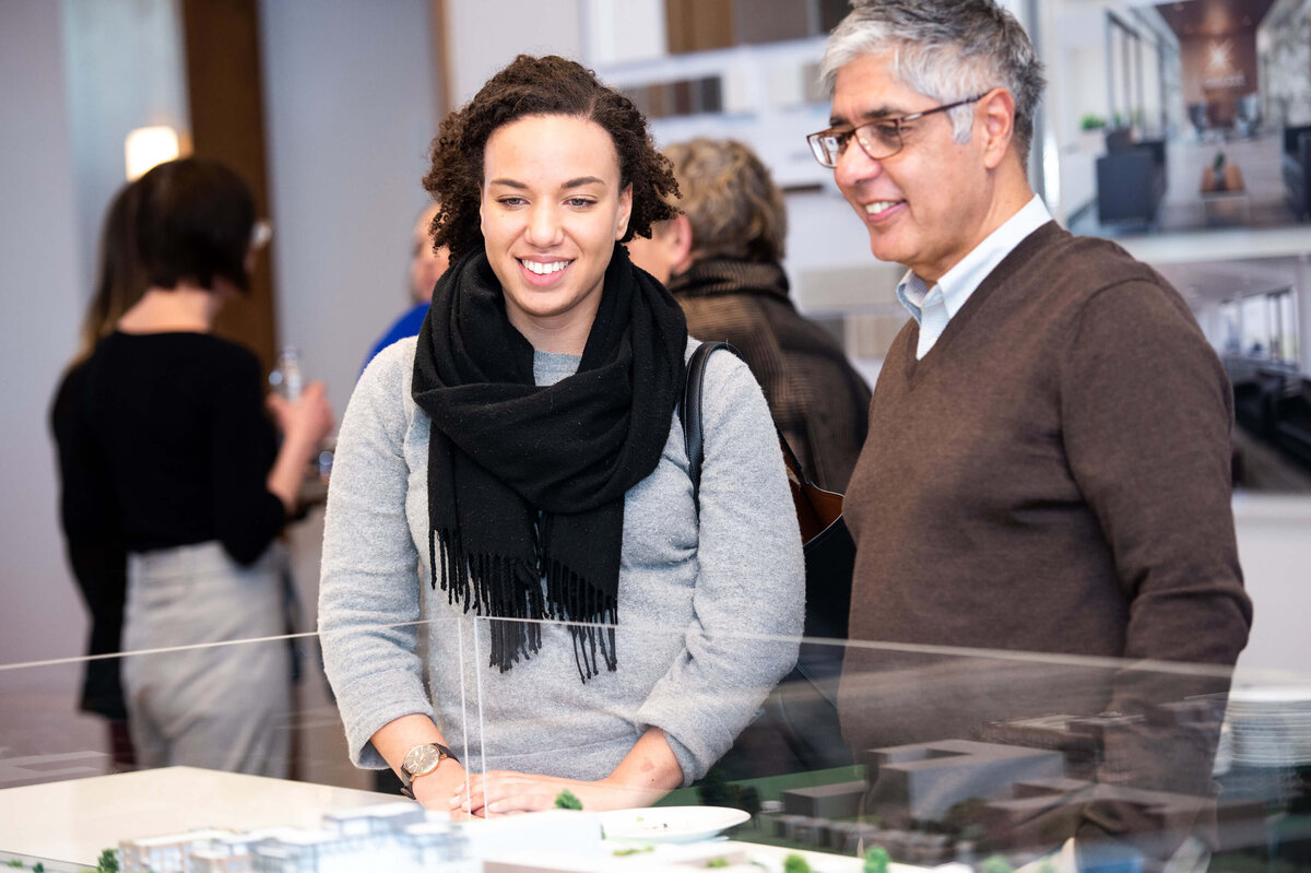 Ottawa event photography showing guests of the eQ groundbreaking event looking at model home plans.  Captured by JEMMAN Photography COMMERCIAL