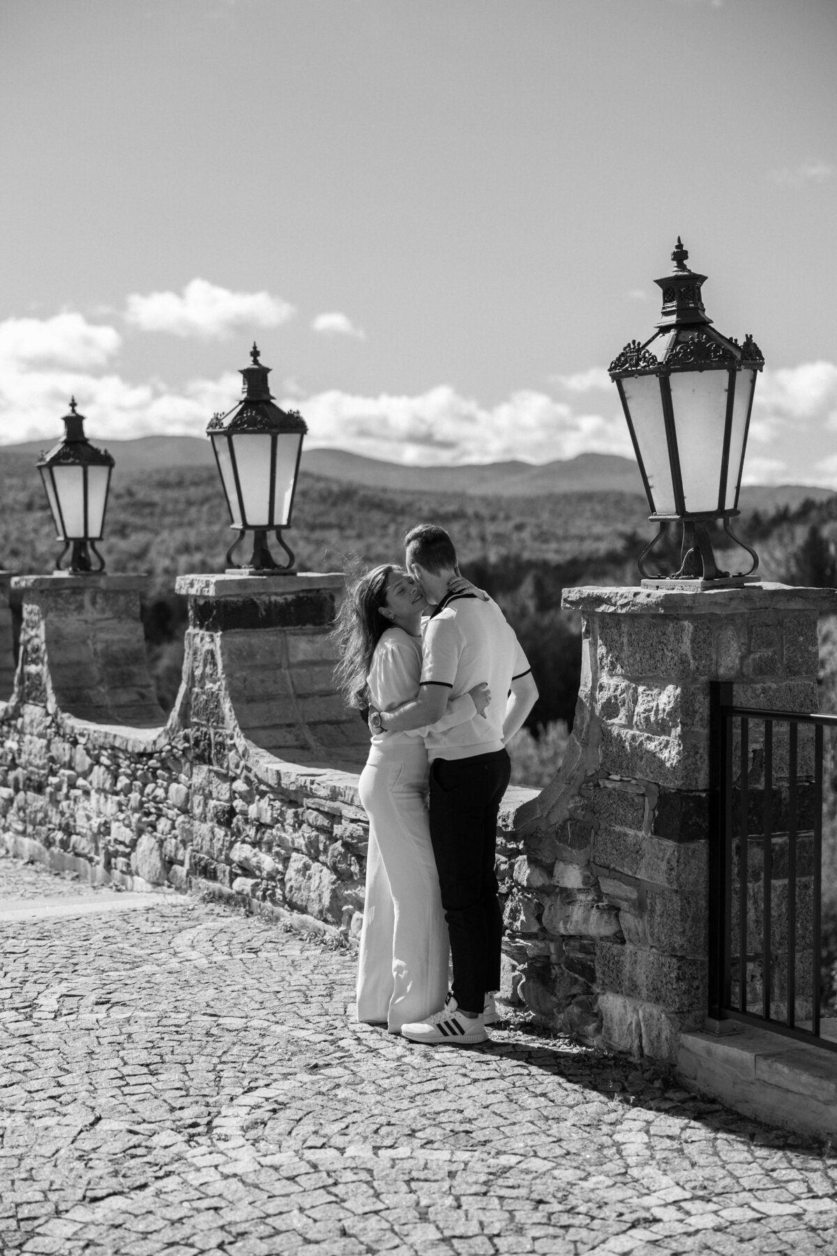 a couple embracing by street lamps
