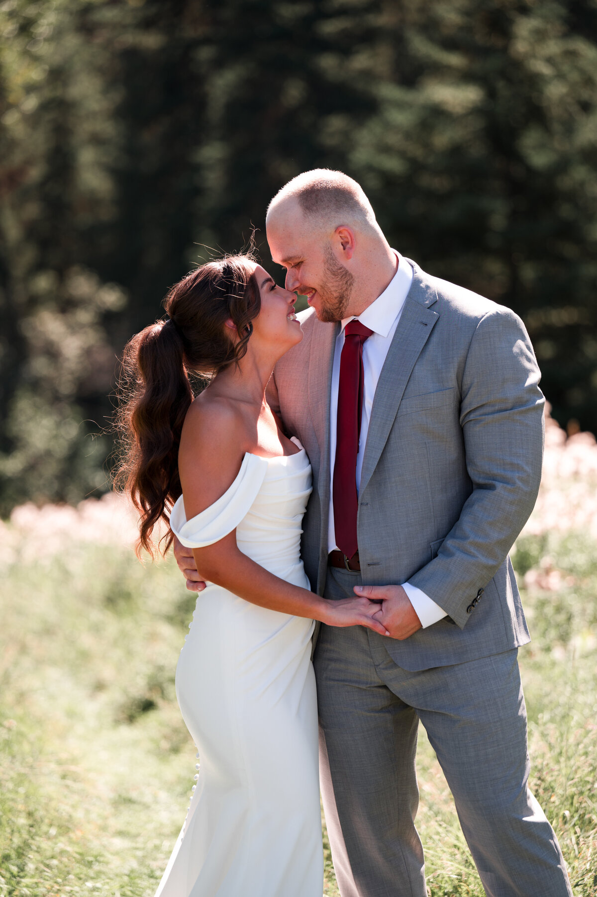 bride and groom standing next to each other holding hands in wedding portrait