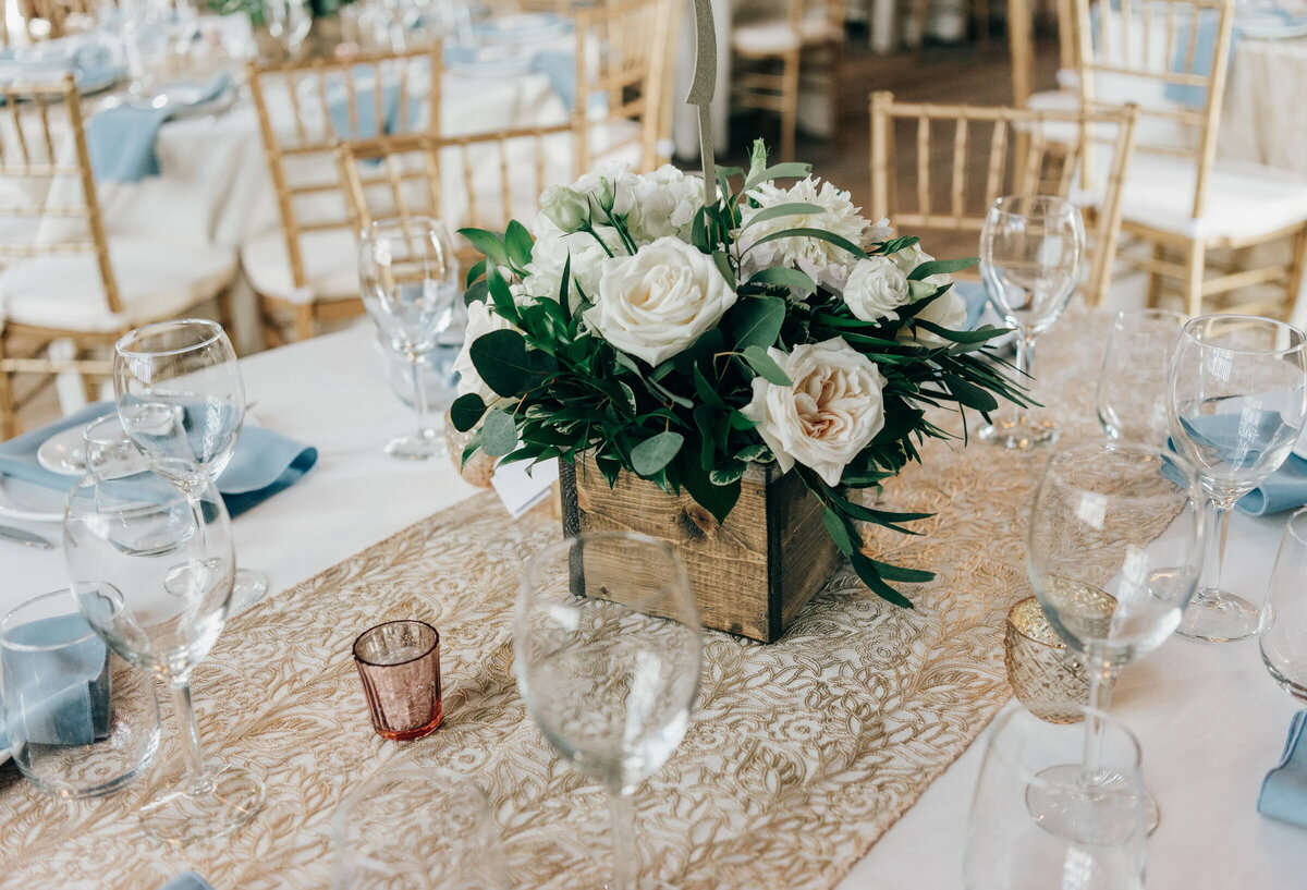 Elegant white floral centre pieces at glamorous barn wedding reception