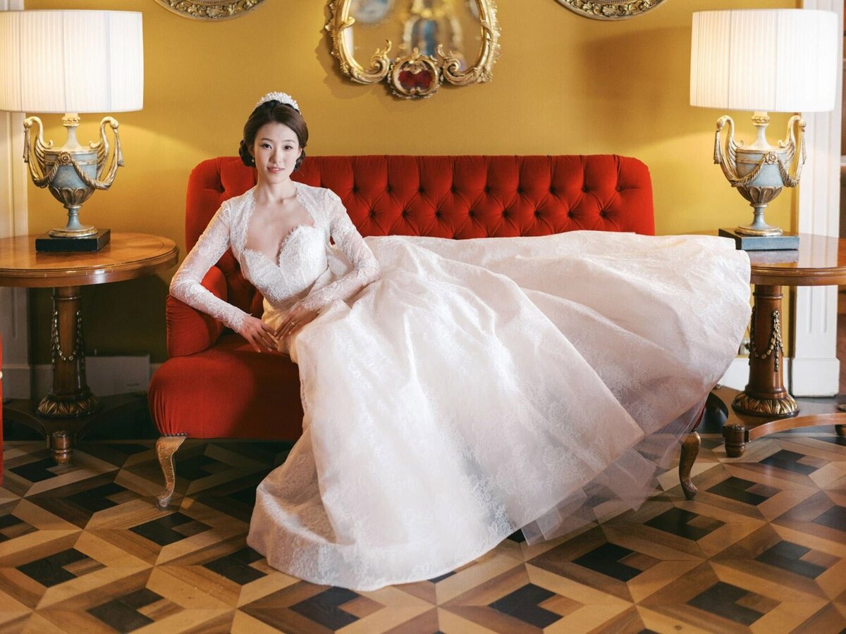 Bride during her Grand Hotel Tremezzo wedding, on a sofa in Monique Lhuillier  wedding dress, by Lake Como Wedding Photographer Andreas K. Georgiou