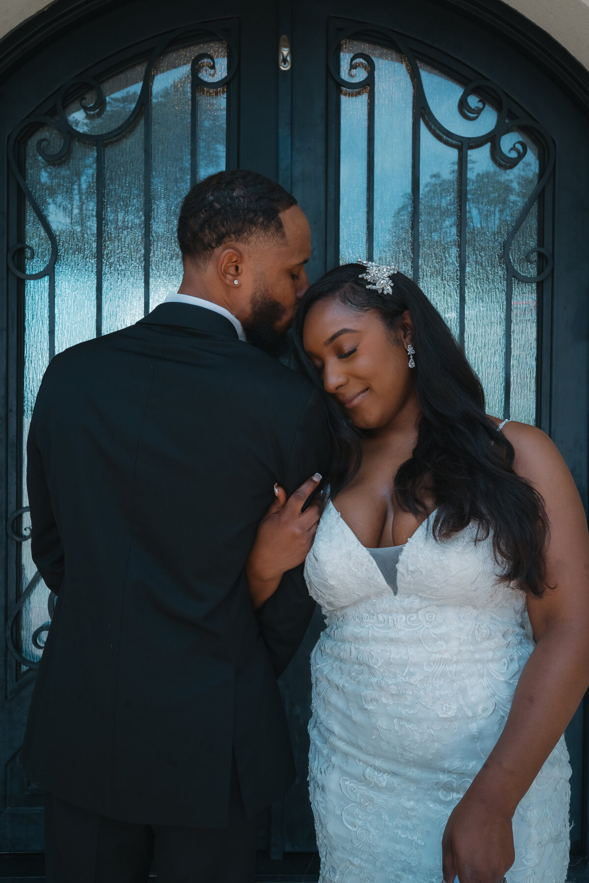 Kissing the top of brides head
