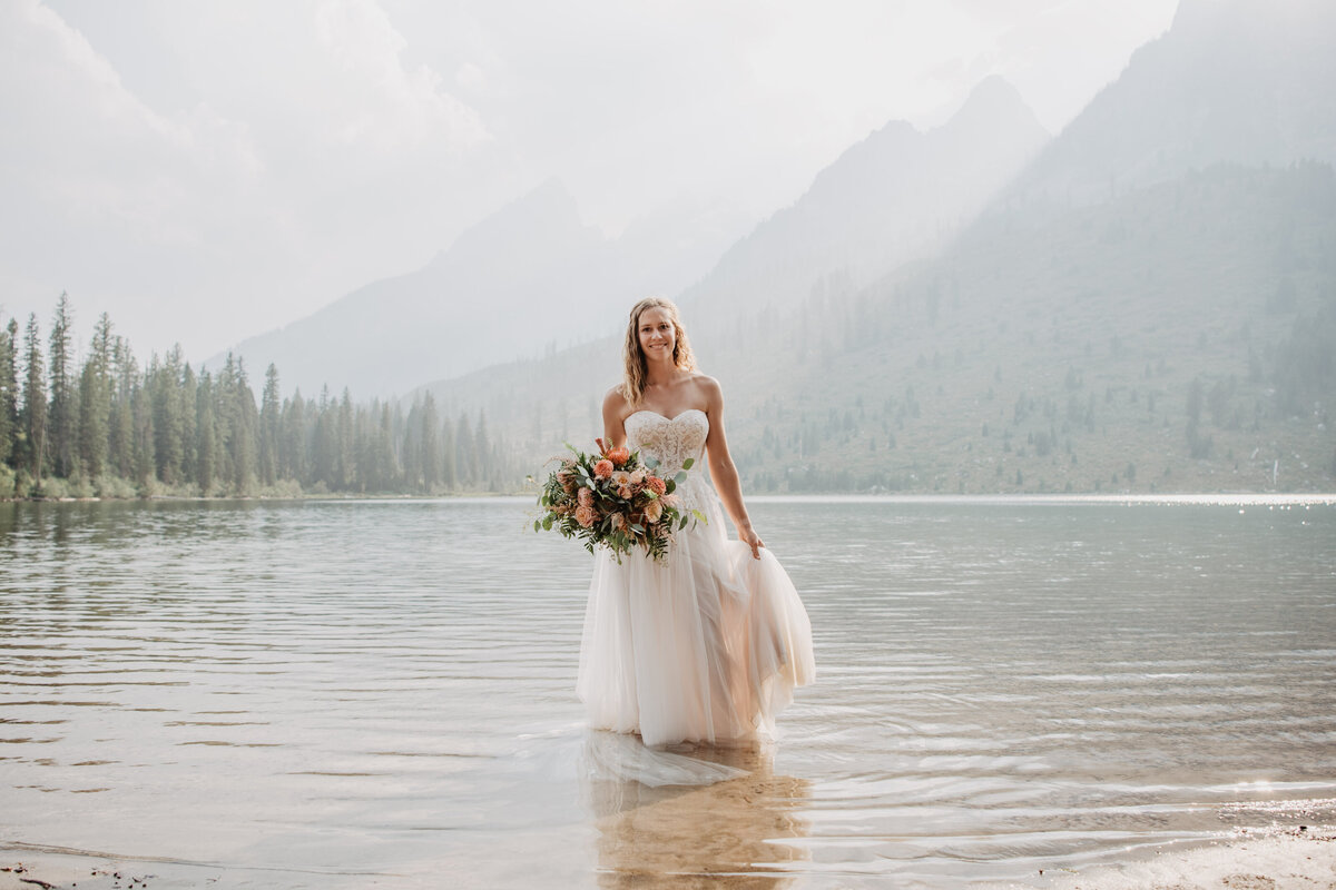 jackson hole photographers capture bridal portraits with bride in water
