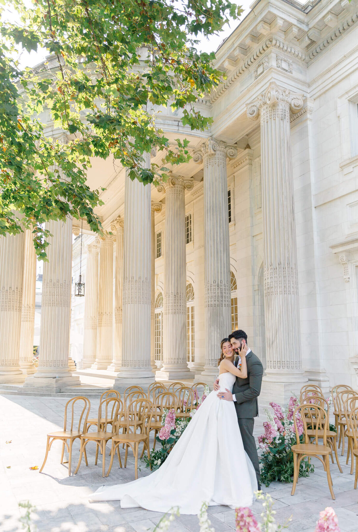 Bride and Groom hugging on the portico at DAR Constitution Hall. Taken by Washington DC Wedding Photographer Bethany Aubre Photography.