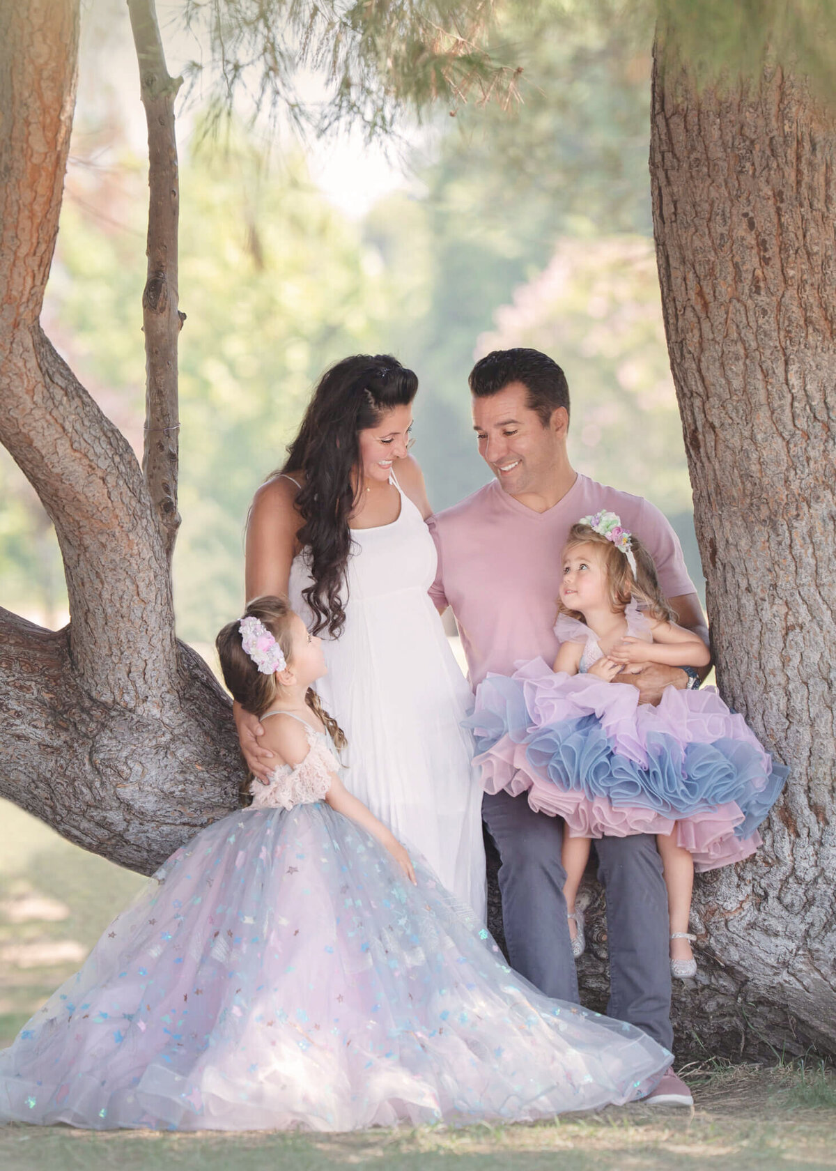 Family of 4 wearing couture photographed sitting in a tree at Lake Balboa Park by Elsie Rose Photography