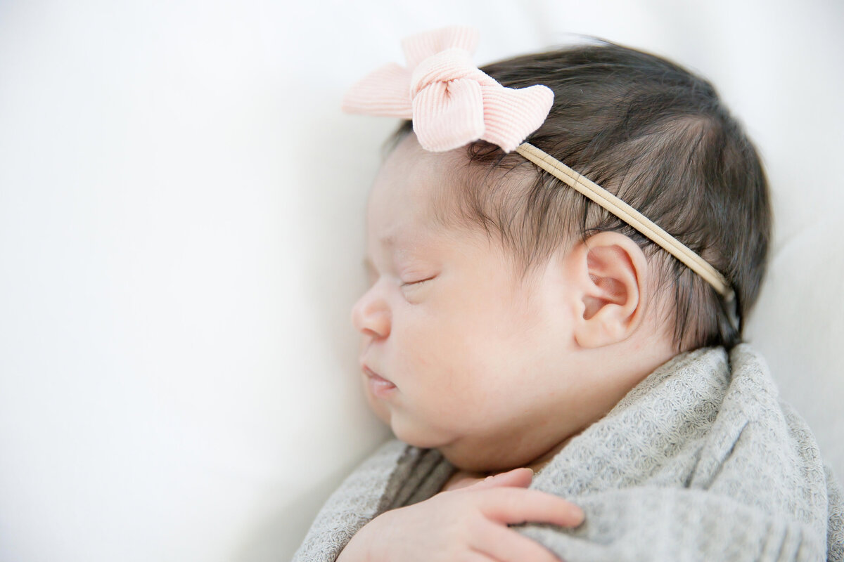 Newborn with pink bow