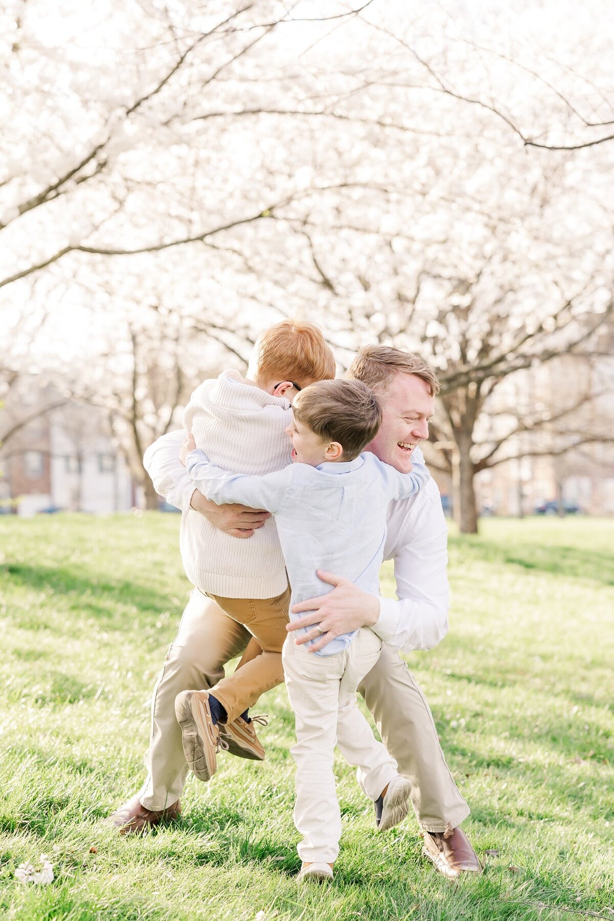 Boy giving their dad a tackle hug by an Ohio family photogapher