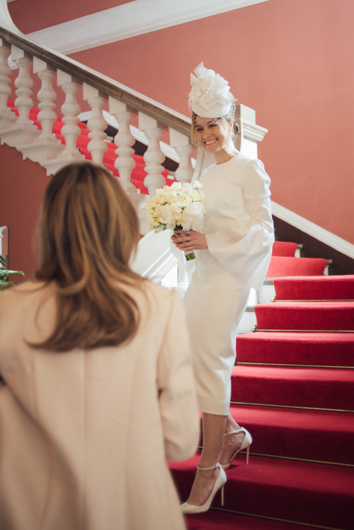A bride walking down a staircase on her wedding day  taken by London Wedding Photographer Liberty Pearl