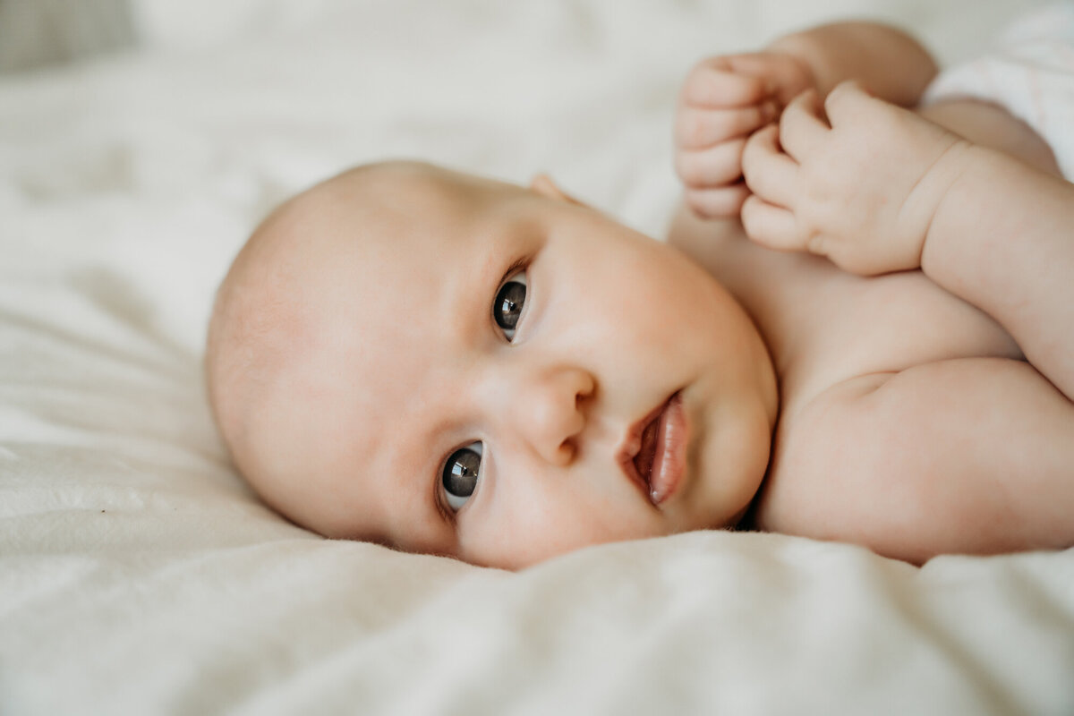 Newborn Photographer, Caucasian baby staring at the camera.