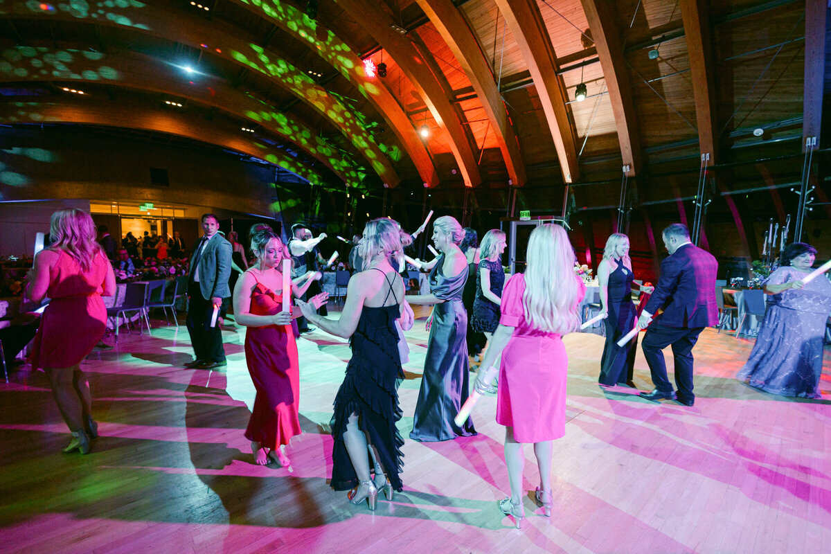 A wedding photo of guests dancing during the reception at Crystal Bridges Museum of American Art